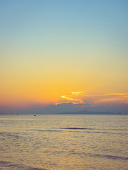 Beautiful beach sunset with blue sea and golden light sky  cloud background