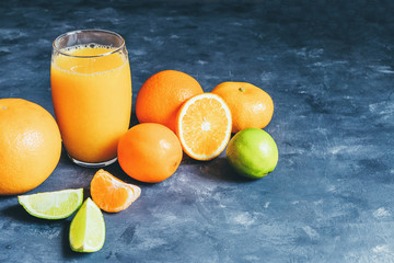 Citrus and juice decorated with mint on a blue background