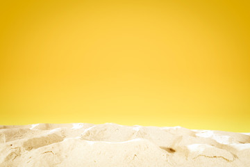 Summer background of sand and yellow wall space 
