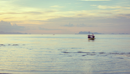 Fototapeta na wymiar Beautiful beach sunset with blue sea and golden light sky cloud background