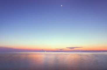 Beautiful beach sunset with blue sea and golden light sky  cloud background