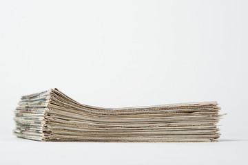 Stack of fresh newspapers on white background