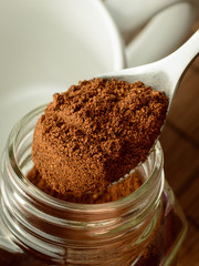 Making coffee in the morning. Taking spoon of coffee out of jar. Putting coffee to the cup