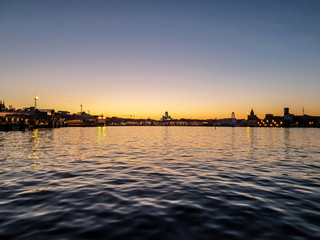 Fototapeta premium The Helsinki city skyline by night from the sea, shot during the beautiful and almost nightless Finnish summer