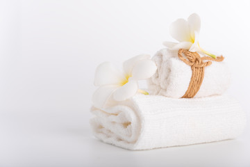 White rolled towels decorate with Frangipani flowers spa object on white background