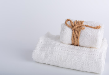 Fototapeta na wymiar Rolled white towels spa object on white background