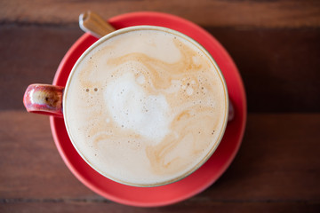 Red hot coffee cup  on wooden  table  background,flat lay