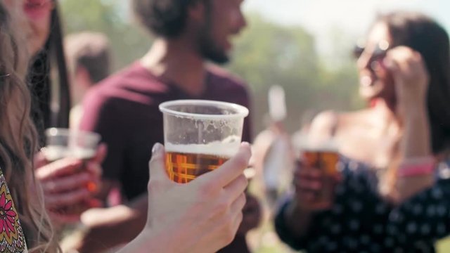 Group of people drinking beer at music festival  
