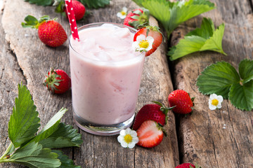 Fresh milk, strawberry on wooden table, assorted protein cocktails with fresh fruits. Natural background.