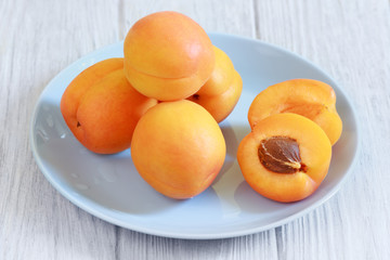 Apricots fruits on white wooden table closeup