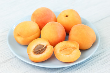 Ripe apricot fruits on table