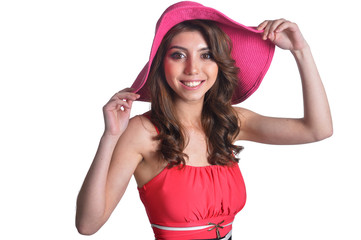 Naklejka premium Close up portrait of beautiful brunette young woman in pink hat on white background