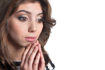 Fototapeta premium Close up portrait of beautiful brunette young woman praying on white background