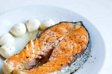 grilled salmon steak on white plate