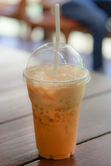 A glass of Thai milk tea on the table
