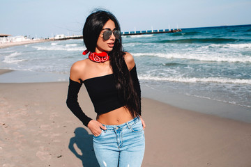 Great pleasure. Fashionable young model looking away. She is posing against wonderful sunset while...