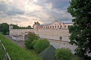 Fototapeta na wymiar Criminal prison, white building with grilles and iron fences. Latvia, Daugavpils, 2019.