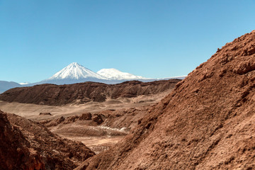 Moonlike landscape of dunes, rugged mountains and rock formations of Valle de la Luna (Moon valley), Atacama desert, Chile