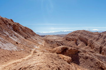 Moonlike landscape of dunes, rugged mountains and rock formations of Valle de la Luna (Moon valley), Atacama desert, Chile