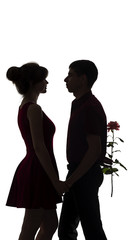 silhouette of boy holding a gift box with a bow behind her back to congratulate girl, a young couple in love on white isolated background,concept holidays, relations between man and woman