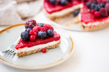 Berry cheesecake slice, fresh frozen red fruits and cheese cake slice, tasty dessert