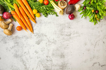 Fresh vegetables top view on concrete table with copy space