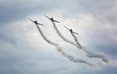 Airplanes on airshow. Aerobatic team performs flight