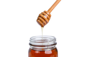 Glass jar honey  and dipper high above isolated on white background