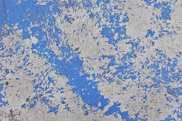 The paint on the cement floor is peeling, Blue background