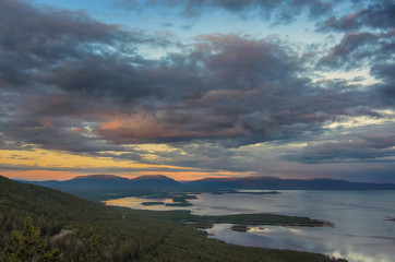 Aerial panorama view of Colorful sunset landscape on the coast of the North Sea. Karelian pine on the rocks on the shore of the White Sea. Coast Murmansk region, Kandalaksha Nature Reserve.