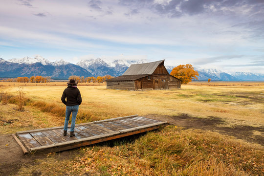 Woman at Mormon Row and Teton Range, Grand Teton National Park, Wyoming