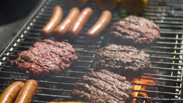 Mixed american barbecue food on hot grill