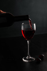 Red wine is poured into a glass
