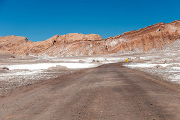 Moonlike landscape of dunes, rugged mountains and geological rock formations of Valle de la Luna (Moon valley) in Atacama desert, Chile