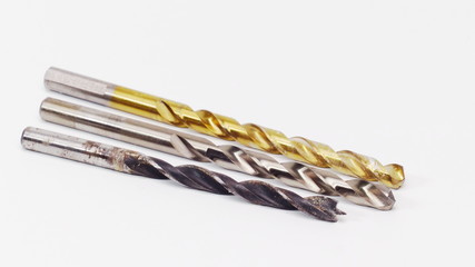 Three drill bits on a white background