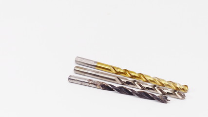Three drill bits on a white background