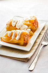 Stuffed pepper with meat and rice on a white square plate