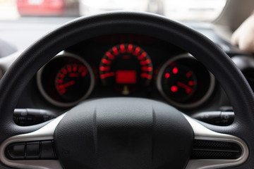 Obraz na płótnie Canvas Blurred background with Modern Car dashboard modern automobile control illuminated panel.Car Driving. Vehicle Steering Wheel.