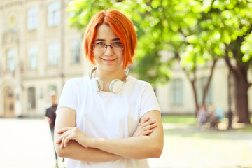 Fototapeta premium Exchange student , holding notebook, thinking on project. walking and talking each other in a campus at sunset with a warm light