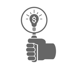 Hand holding magnifying glass over a light bulb with dollar symbol icon. Searching for an idea concept