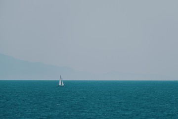Sailboat in the blue sea in summer