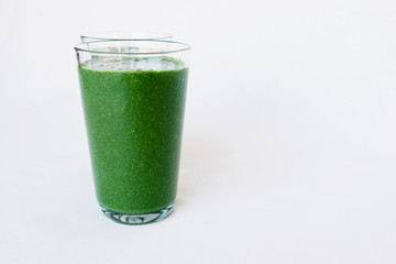 Fresh green smoothie with spinach leaves, banana, coconut milk, spirulina and flax seeds. Healthy lifestyle, raw vegetarian food