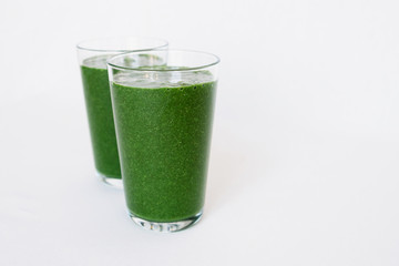 Green smoothie. Fresh spinach, banana, coconut milk, spirulina powder and flax seeds smoothie. Healthy summer food