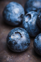 Ripe blueberries on the rustic background. Selective focus. 