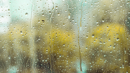 rain drops on the window. rainy window in autumn or spring. abstract view. rainy season. droplets on glass window  shield. 