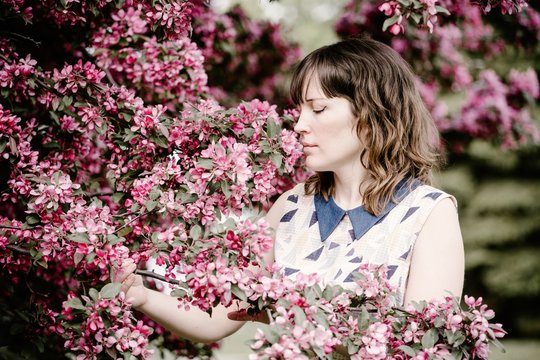Woman smelling pink flowers outdoor