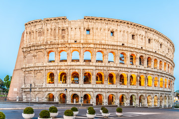 Fototapeta na wymiar Colosseum, or Coliseum. Illuminated huge Roman amphitheatre early in the morning, Rome, Italy