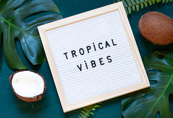 Tropical vibes text on felt board. Concept vacation card flat lay. Top view