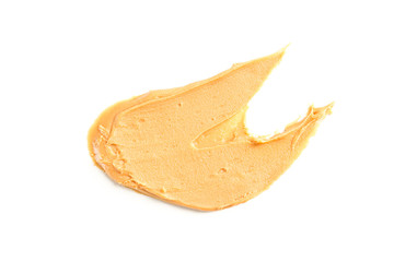Creamy peanut butter isolated on white background. A traditional product of American cuisine