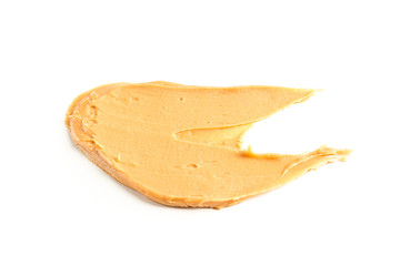 Creamy peanut butter isolated on white background. A traditional product of American cuisine